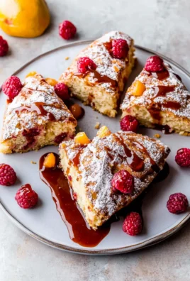 Freshly Baked Glazed Cranberry Orange Scones on a Plate